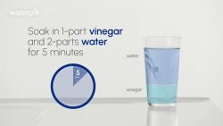 Soak water flosser tip in vinegar and warm water